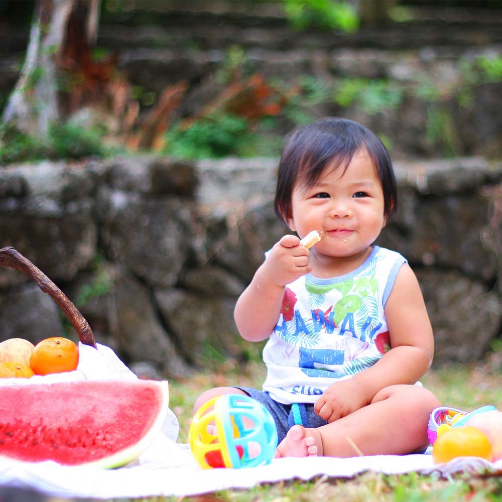 Asian baby with food and toys