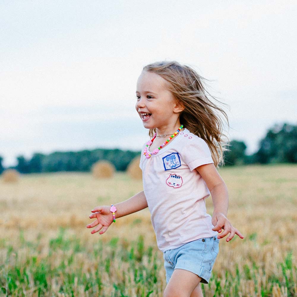 Little girl playing in a field