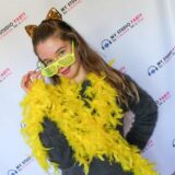 Girl with yellow and gold accessories posing on the red carpet with My Studio Party