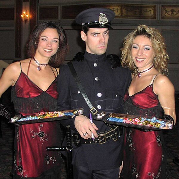 Man in police costume with women at Cabaret theme night party