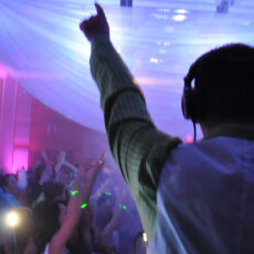 Dj playing music and dancing at a party