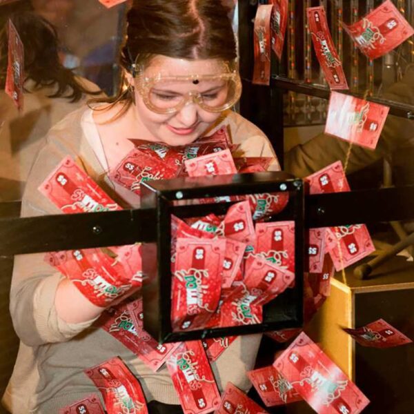 Girl in transparent box with money tornado