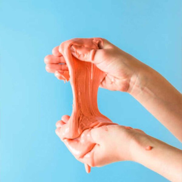 Playing with orange slime on a blue background