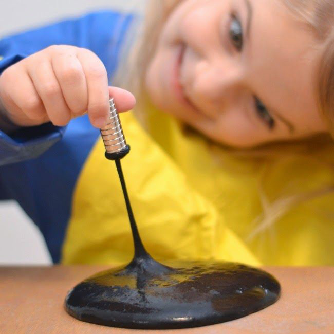 black magnetic slime stretched with a magnet