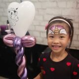 balloon twisting with white heart