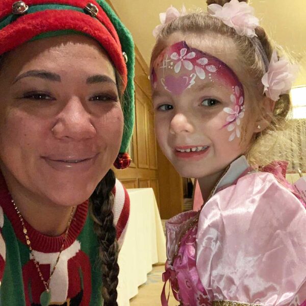woman dressed as elf with princess girl in pink dress