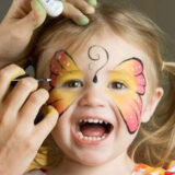 young girl with butterfly face paint