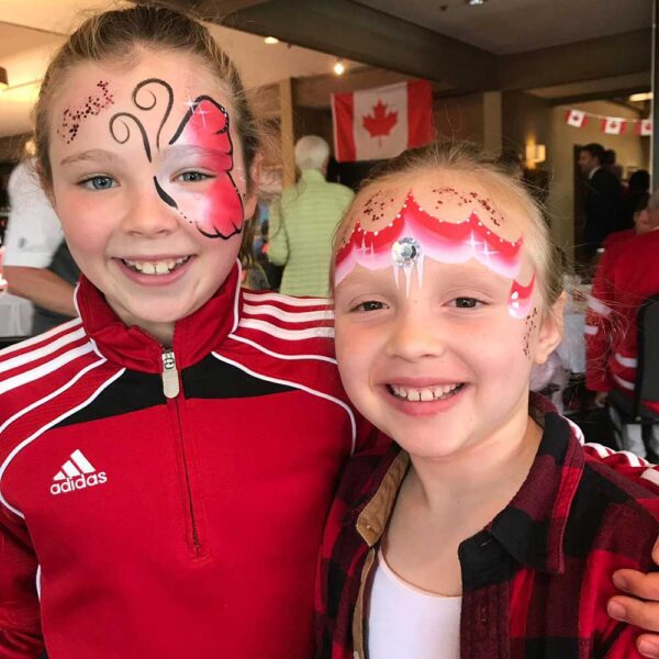 two girls with red face painting
