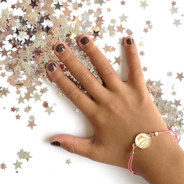 dark glitter nailpolish on young girl hand