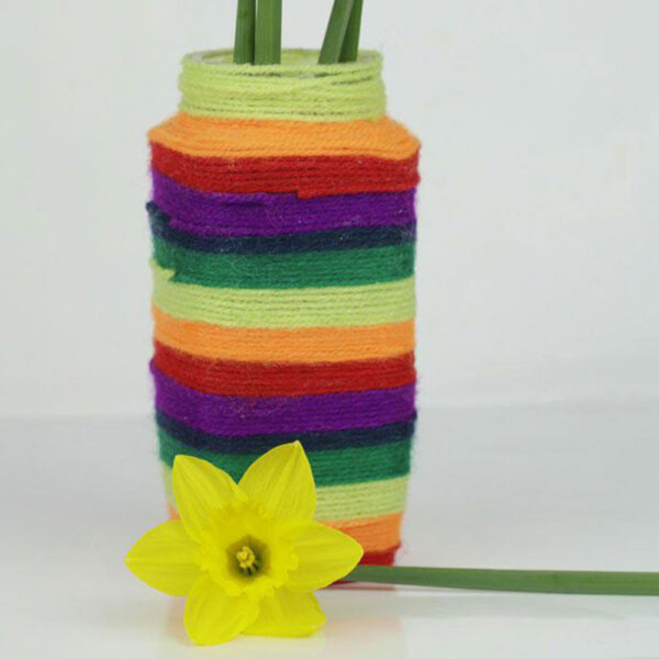 arts and crafts vase colored with yarn