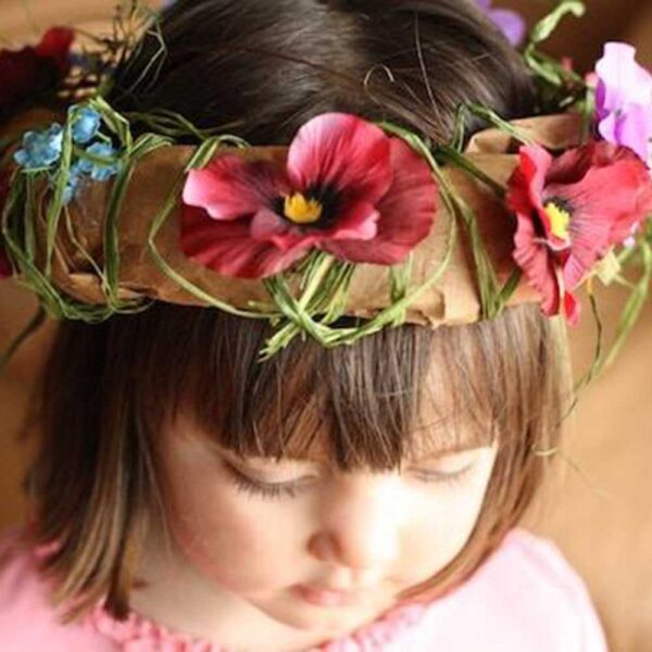 head crown made out of paper and flowers on young girl head