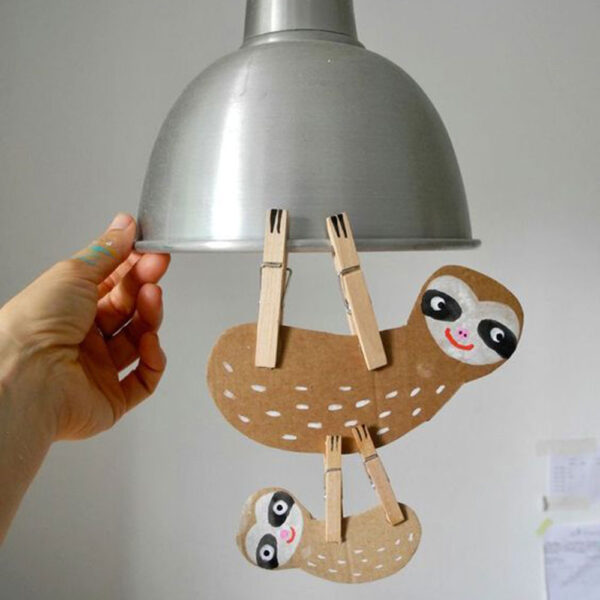 sloth paper craft hanging from light fixture